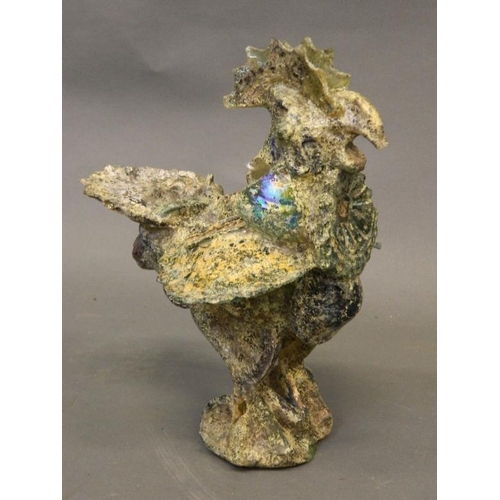 66 - An Eastern iridescent glass figure of a cockerel, 10½