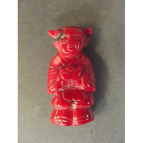 73 - A small Oriental carved coral figure, 2