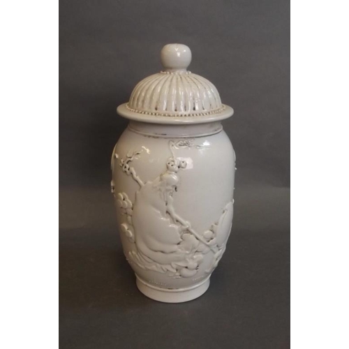 74 - A Chinese blanc de chine jar and cover with raised decoration of Lohan and a monkey, impressed mark ... 