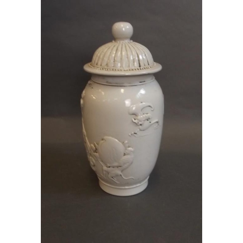 74 - A Chinese blanc de chine jar and cover with raised decoration of Lohan and a monkey, impressed mark ... 