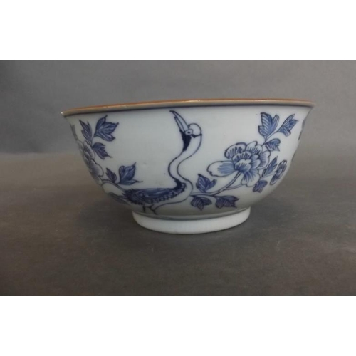 75 - An Oriental porcelain blue and white bowl decorated with cranes amongst flowers, 5½