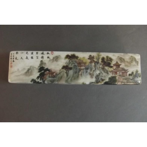 81 - A Chinese porcelain scroll weight decorated in the famille verte palette with houses amongst trees, ... 