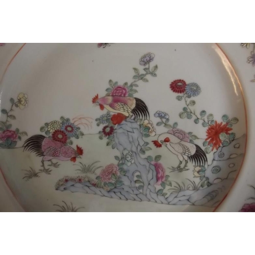 82 - A C19th Chinese porcelain plate decorated in bright enamels with cockerels in a flower garden, 10