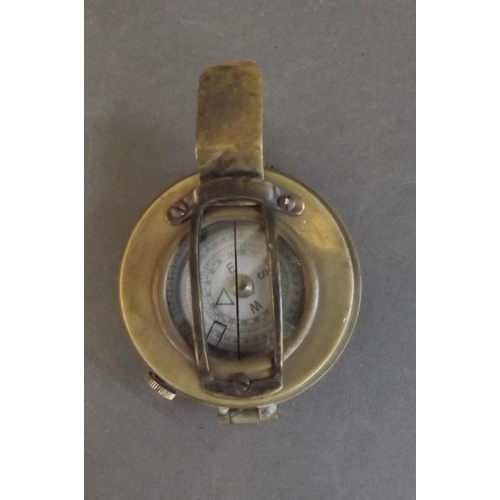 84 - A brass cased field compass, engraved 'T.G.C. & Co. Ltd., London', 2½