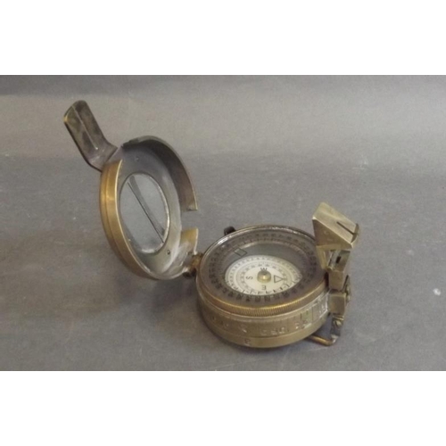 84 - A brass cased field compass, engraved 'T.G.C. & Co. Ltd., London', 2½