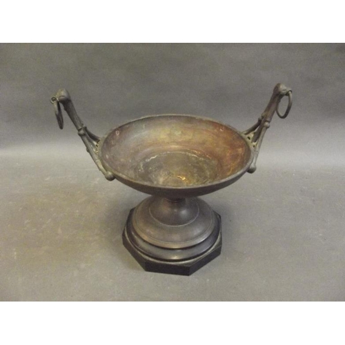 94 - A Gothic bronze pedestal centrepiece stand with raised ring handles, on a hardstone base, 8½