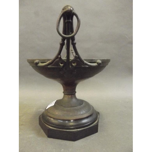 94 - A Gothic bronze pedestal centrepiece stand with raised ring handles, on a hardstone base, 8½