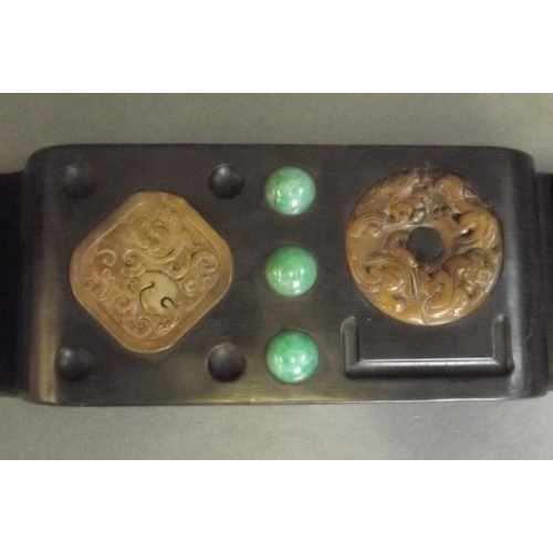 95 - A Chinese hardwood brush rest with inset soapstone pi-disc, jade beads etc, 10½