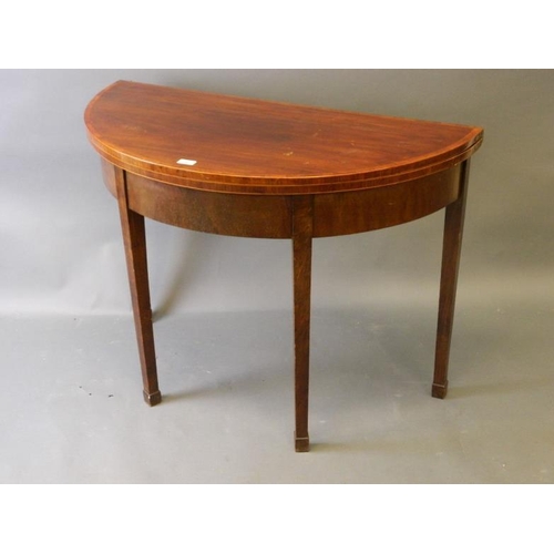 914 - A C19th mahogany demi-lune tea table with satinwood banded top, on square tapering supports and spad... 