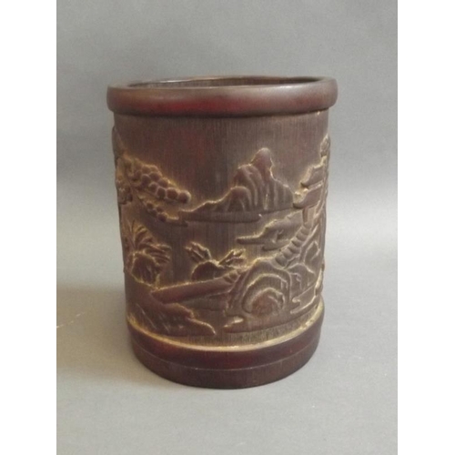 29 - A Chinese carved bamboo brushpot decorated with figures taking tea, 6½