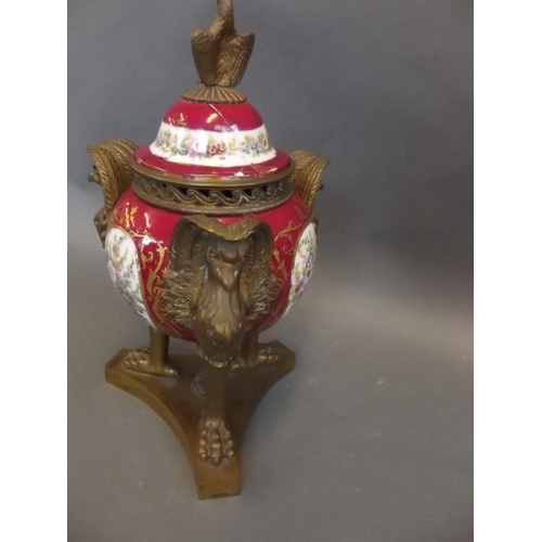 45 - A French porcelain lidded urn with ornate ormolu mounts and stand, the body painted with panels of f... 