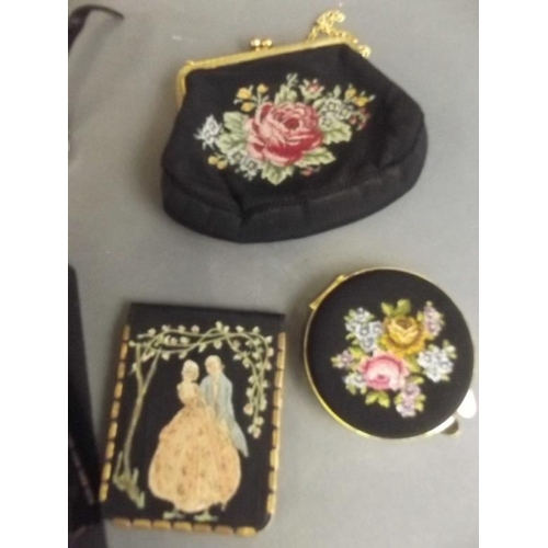 26 - A trinket box containing embroidered purse compacts, nail buffer etc