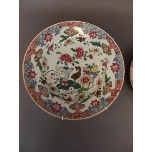 3 - A Chinese porcelain shallow dish decorated with figures in a garden within a famille rose decorated ... 