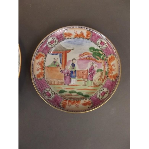 3 - A Chinese porcelain shallow dish decorated with figures in a garden within a famille rose decorated ... 