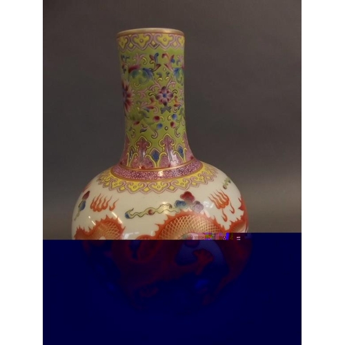 32 - A Chinese porcelain bulbous vase with slender neck, the body painted in bright enamels with dragons ... 