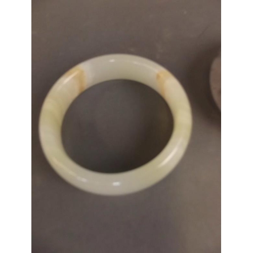 34 - A Chinese white jade bangle, and another tri-colour bangle, 3