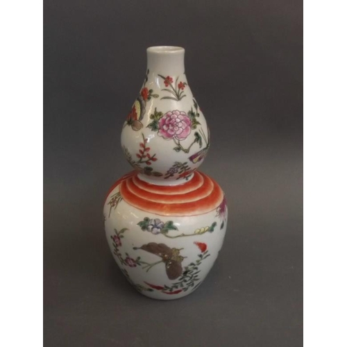 35 - A Chinese Sung style porcelain double gourd vase with painted enamel butterfly decoration, 6 charact... 