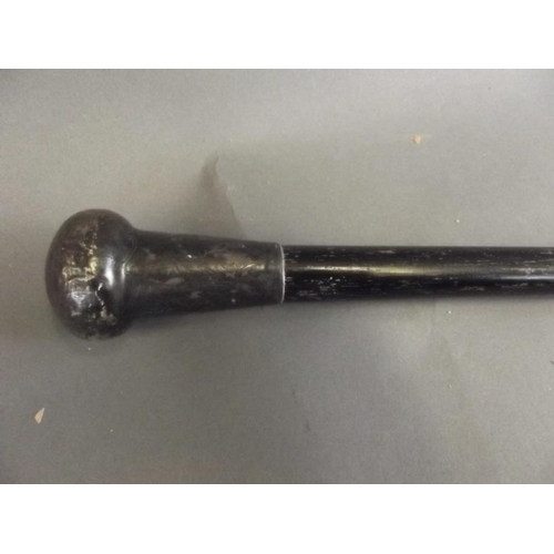 39 - An ebonised dandy cane with a silver plated handle