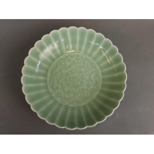 40 - A Chinese celadon glazed dish with petal rim and incised lotus flower decoration, seal mark to base,... 