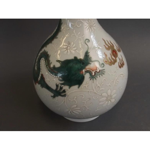 43 - A Chinese porcelain bottle vase with green enamel dragon and white enamel lotus decoration, seal mar... 