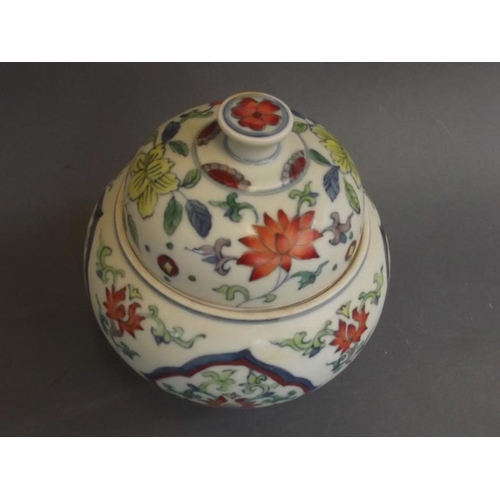 48 - A Chinese Doucai enamel porcelain jar and cover with foliate decoration, on tripod supports, 6 chara... 