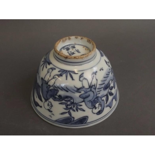 50 - A Chinese blue and white porcelain rice dish decorated with five boys playing in a garden, 6 charact... 