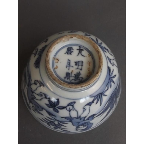 50 - A Chinese blue and white porcelain rice dish decorated with five boys playing in a garden, 6 charact... 