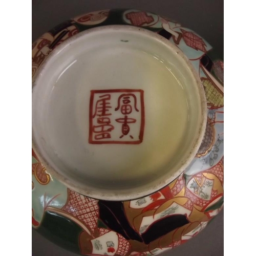 50B - A Chinese blue and white octagonal bowl decorated with figures in a garden, 6 character mark to base... 