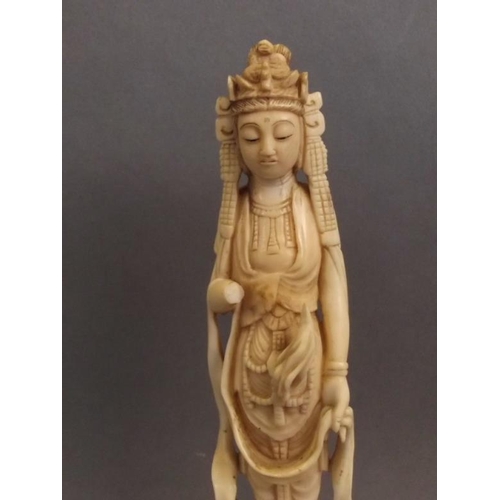 50J - A Chinese carved ivory figure of Quan Yin standing upon a lotus blossom, 7