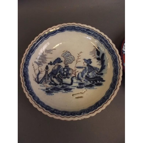 50S - A late C18th/early C19th Delft blue and white pottery dish decorated with figures in a garden, in th... 