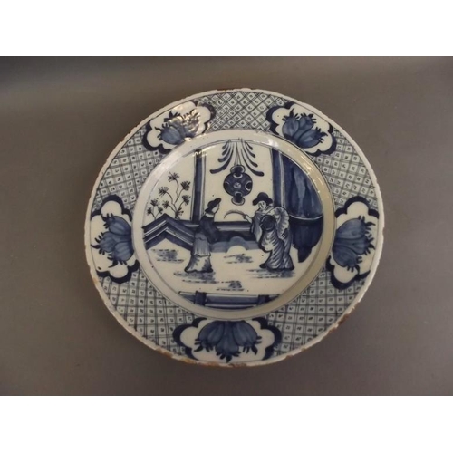 50U - A large early Delftware plate decorated with two ladies, in the Chinese manner, the back marked 'S7'... 