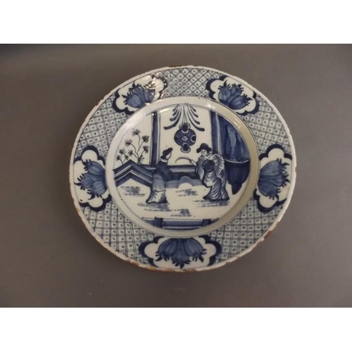 50U - A large early Delftware plate decorated with two ladies, in the Chinese manner, the back marked 'S7'... 