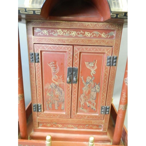 817 - A Chinese red lacquer shrine with gilt chinoiserie decoration, 26