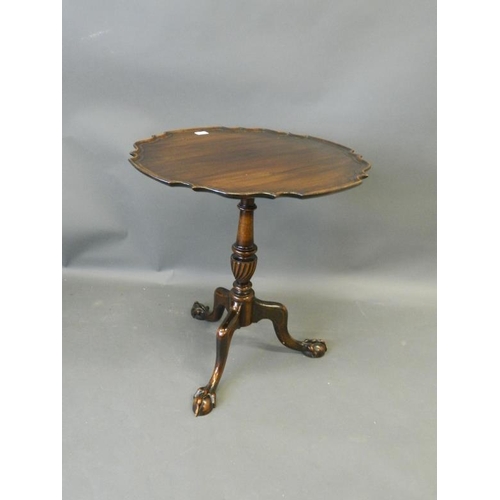 818 - A C19th mahogany tilt-top occasional table with shaped dish top, on a carved and turned column and t... 