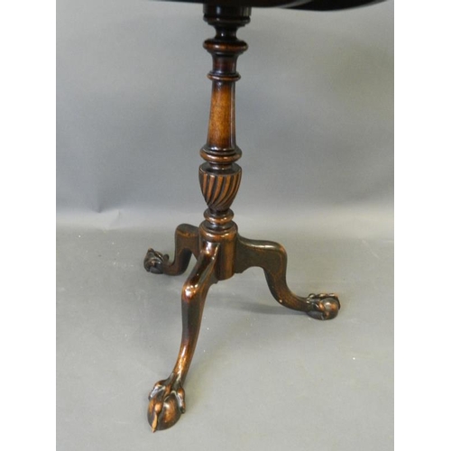 818 - A C19th mahogany tilt-top occasional table with shaped dish top, on a carved and turned column and t... 