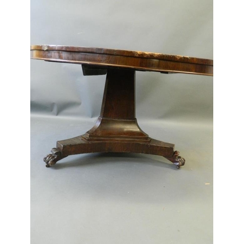 819 - A Victorian rosewood circular top breakfast table on a shaped column and triform platform base, rais... 