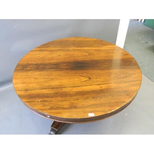 819 - A Victorian rosewood circular top breakfast table on a shaped column and triform platform base, rais... 