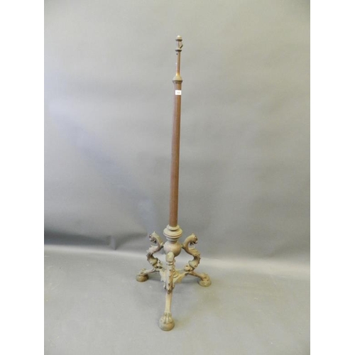 820 - A bronze standard lamp base with fluted column, on tripod supports in the form of dragons, on claw f... 