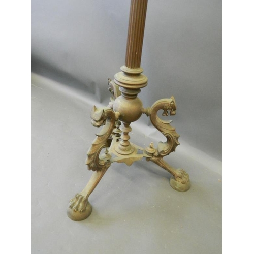 820 - A bronze standard lamp base with fluted column, on tripod supports in the form of dragons, on claw f... 