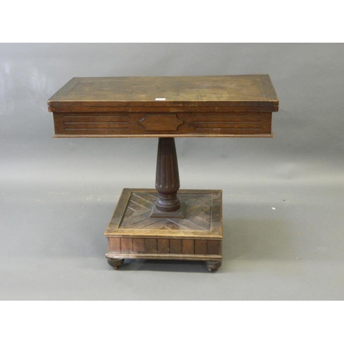 826 - A Victorian oak fold-over card table on fluted supports and square platform base, 35