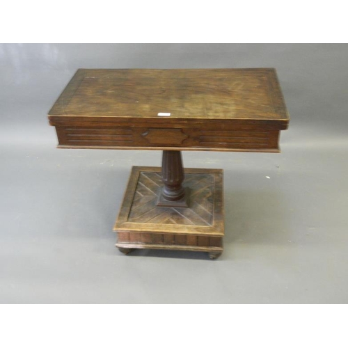 826 - A Victorian oak fold-over card table on fluted supports and square platform base, 35