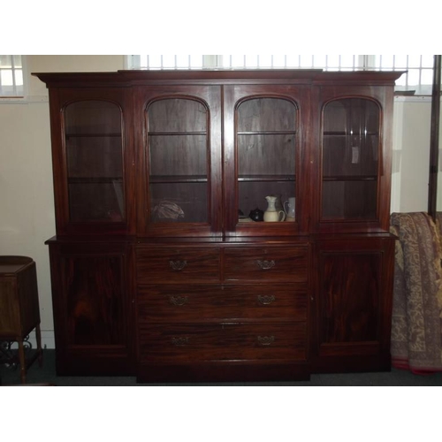 828 - A C19th mahogany breakfront bookcase, the lower section with two cupboards flanking four drawers, th... 