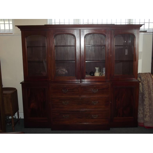 828 - A C19th mahogany breakfront bookcase, the lower section with two cupboards flanking four drawers, th... 