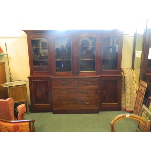 828 - A C19th mahogany breakfront bookcase, the lower section with two cupboards flanking four drawers, th... 