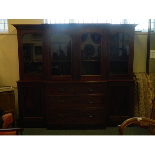 828 - A C19th mahogany breakfront bookcase, the lower section with two cupboards flanking four drawers, th... 