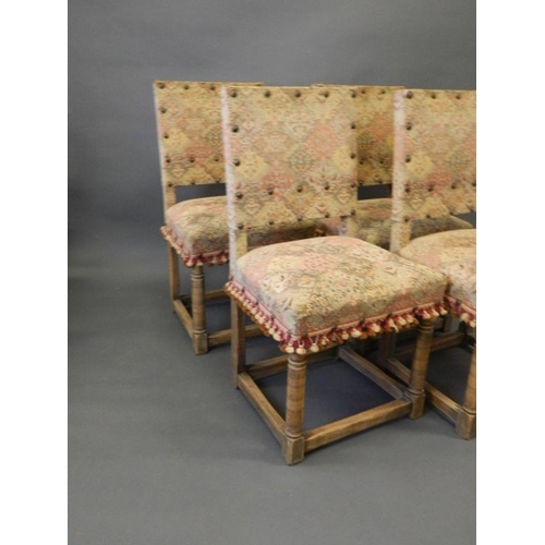 836 - A set of oak dining chairs with brass studded decoration and tasselled covers, Best Bid