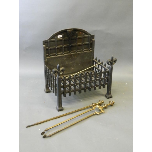 842 - A cast iron fire basket with portcullis design back plate and fleur-de-lys legs, together with brass... 