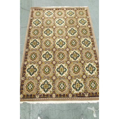 850 - A Chinese wool carpet with all over design on a coffee coloured ground, 79