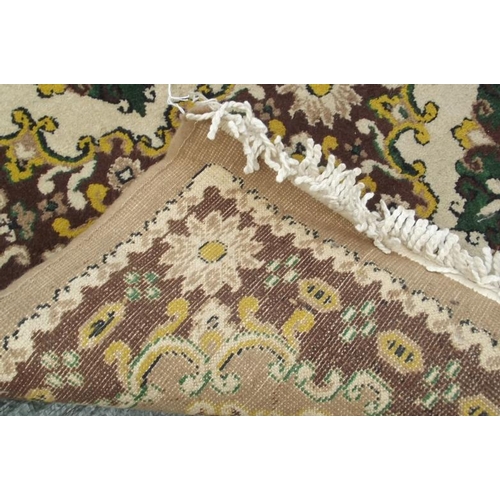 850 - A Chinese wool carpet with all over design on a coffee coloured ground, 79