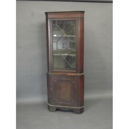 851 - A late C19th/early C20th mahogany corner display cabinet with astragal glazed door above a candle sl... 